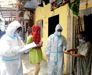 Healthcare workers doing door to door check-up of COVID-19 test of the Bail Bazaar, Kurla slum area, in Mumbai on Tuesday. (ANI Photo)