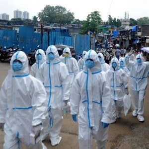 Health workers wearing protective suits arrive for a COVID-19 health check-up camp, at Appa Pada, Malad East in Mumbai on Thursday. (ANI Photo)