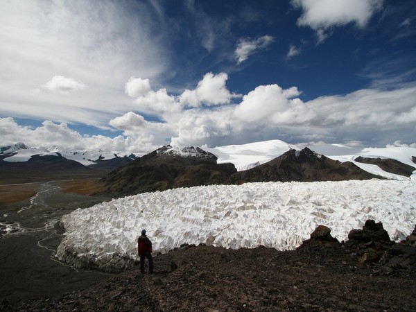 A man stands near the Jianggudiru Glacier on Geladaindong Mountain